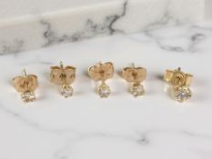 Two pairs of diamond solitaire earring studs, plus a further single stud, set in 9ct gold.