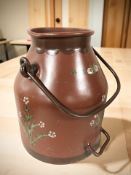 A painted metal milk churn with swing handle, lacking lid, height including handle 50 cm.
