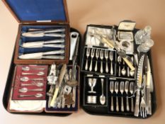 A group of boxed cutlery sets, perfume bottles including one with silver mount,