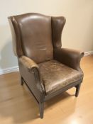 A 20th century studded brown leather wingback armchair, width 79 cm.