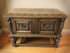 A continental heavily carved oak two door side cabinet, 118 cm x 49 cm x 86 cm.