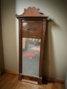 A 19th century continental mahogany mirror, 132 cm x 50 cm.