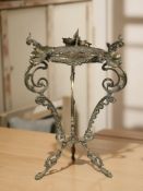 An ornate brass tripod plant stand, height 61 cm.