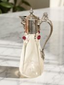 A clear and ruby glass decanter, with silver-plated cap and handle in the form of a mermaid,