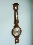 A 19th century inlaid mahogany banjo barometer with silvered dial.