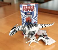 An electric remote control dinosaur toy and a slushie maker, in box.