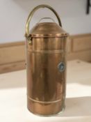 A copper cylinder with brass handle, height 77 cm.