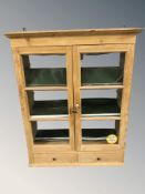 A glazed pine double door wall cabinet, 87 cm x 35 cm x 110 cm.