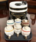 A large Valdespino ceramic sherry barrel, height 30 cm, and six similar smaller barrels.