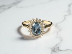 A blue topaz and diamond cluster ring in 9ct gold, size L1/2 CONDITION REPORT: 2.