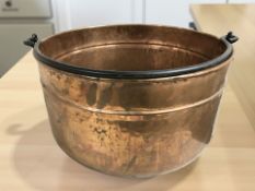 A large copper pot with swing handle, diameter 46 cm.