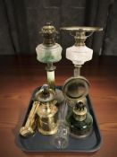 Four various oil lamps.