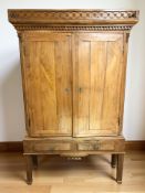 A continental oak and elm double door cabinet, 122 cm x 38 cm x 191 cm.