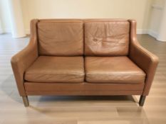 A contemporary Danish two seater tan leather settee, width 127 cm.