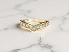 A 9ct gold ring channel-set with peridots, size R CONDITION REPORT: 2.