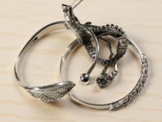 A group of white metal bracelets and bangles, stamped 925 or 999.