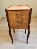 A continental kingwood veneered three drawer bedside chest, width 35 cm.