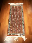 An Azerbaijani rug, 155 cm x 61 cm.