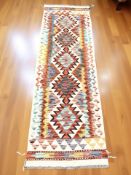 A Chobi Kilim runner, 198 cm x 62 cm.