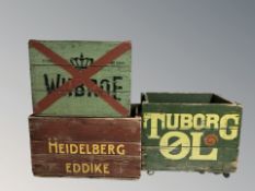 Three painted pine bottle crates bearing advertising, largest 57 cm wide.