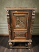 A continental heavily carved oak single door cabinet, 76 cm x 45 cm x 137 cm.