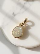 An opal and diamond pendant, set in 15ct gold, length 2cm. CONDITION REPORT: 1.