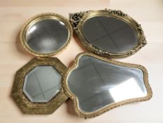 A group of brass and gilt mirrors.