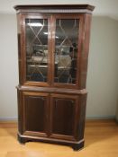 A reproduction mahogany glazed double door corner cabinet, height 177 cm.