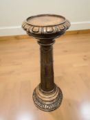 A reproduction carved plant pedestal,