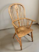 An elm spindle back Windsor chair, width 55 cm.