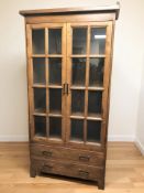 A reproduction elm glazed double door cabinet, 99 cm x 36 cm x 192 cm.