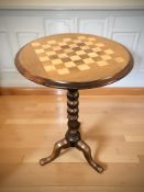 A reproduction tripod chess board table,