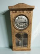 An early 20th century oak eight day wall clock,