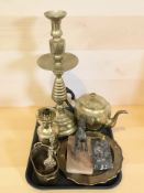 A large brass candlestick, oil lamp, tea pot,