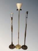 Three 20th century Scandinavian metal and teak standard lamps, tallest 164 cm.