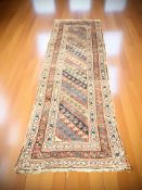 A late 19th century Caucasian runner, 260 cm x 91 cm. CONDITION REPORT: Heavily worn.