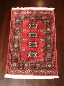 A Lahore Bokhara rug, Pakistan, 100 cm x 65 cm.