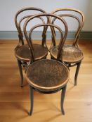 A set of three bentwood chairs.