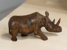 A carved ironwood rhinoceros, length 28 cm.