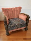 A continental heavily carved oak armchair with figural supports, width 80 cm.