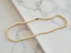 A single-strand cultured pearl necklace with 14ct white gold clasp,