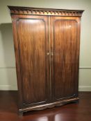 A reproduction mahogany double door wardrobe,
