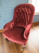 A late Victorian armchair in buttoned burgundy fabric