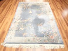 A Chinese woolen rug on blue ground,