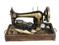 A Singer electric sewing machine with lead and pedal,