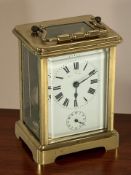 A French brass carriage timepiece, height 14.5 cm including handle, with key.