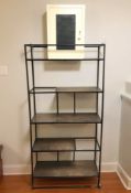 An enamelled metal open bookcase with metal shelves,
