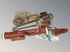A group of vintage tennis and badminton rackets, child's golf clubs,