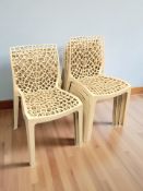 A set of seven plastic stackable garden chairs