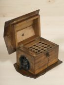 A wooden cigar dispenser in the form of a dog in a kennel, with key, length 25 cm.